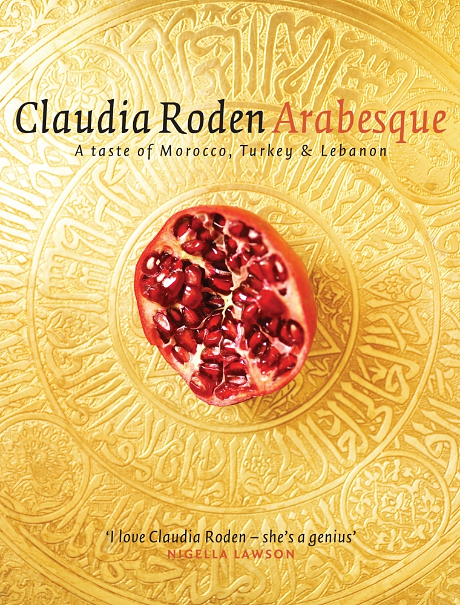 Book cover of Arabesque: A cut pomegranate facing up on a gold background.