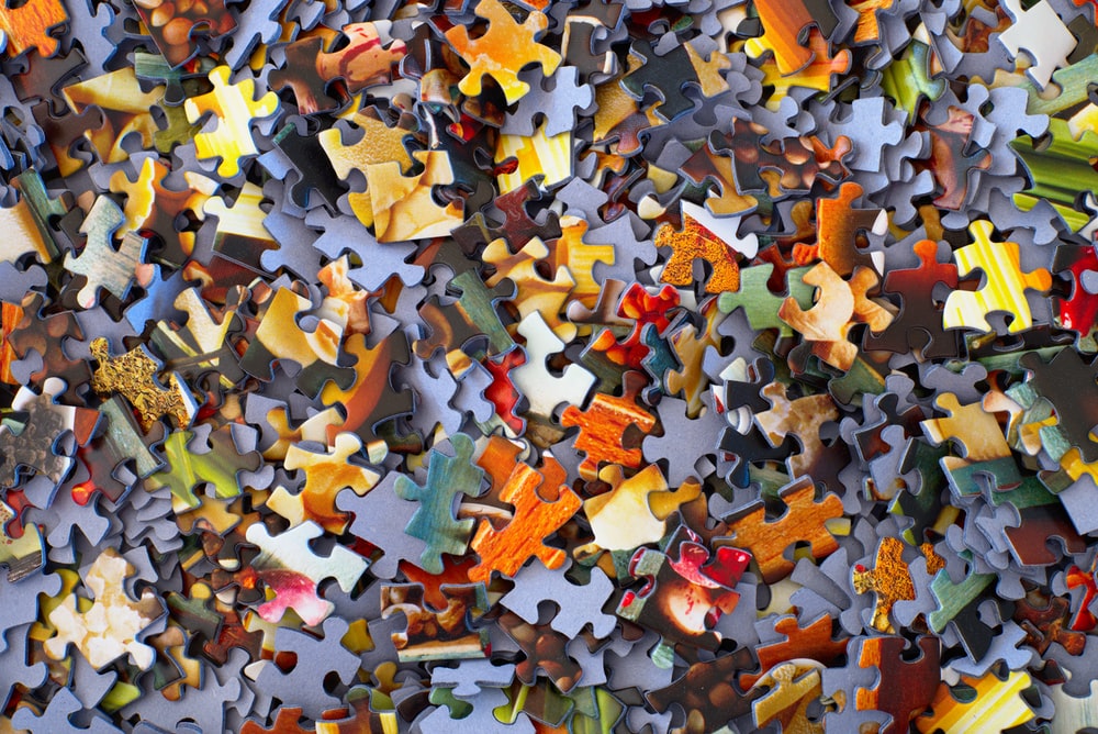 pile of jigsaw puzzle pieces in a range of colors