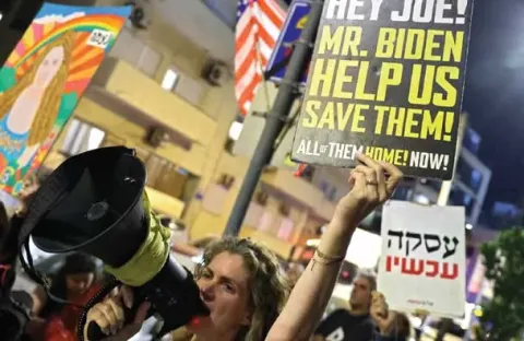 A group of protestors holding signs.