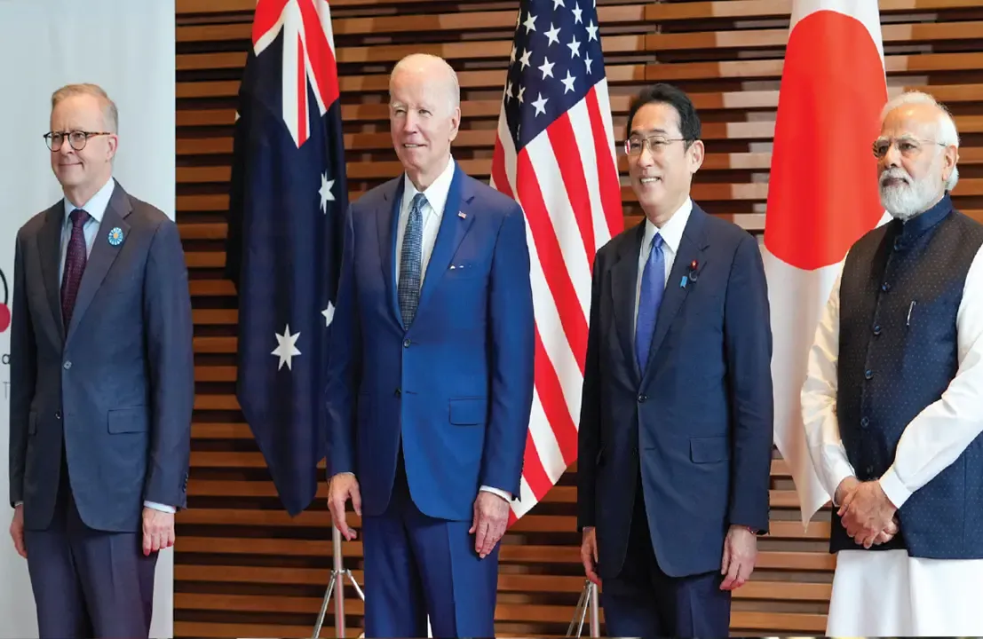 Joseph Biden standing in a row with other individuals.