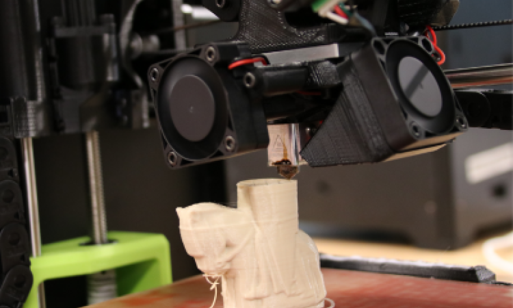 Bed of 3D printer partway through a print