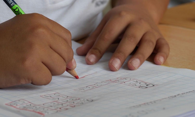 Child doing math on gridded paper