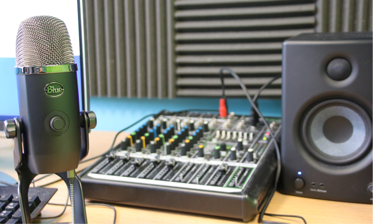 Radio station recording equipment with sound baffle in background